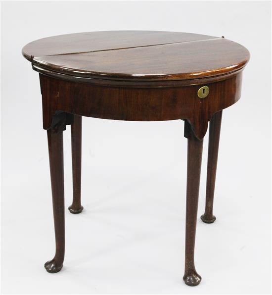 A mid 18th century mahogany triple fold over demi lune card table, W.2ft 6in.